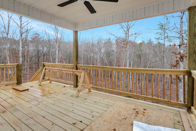 wooden deck with ceiling fan and a forest view