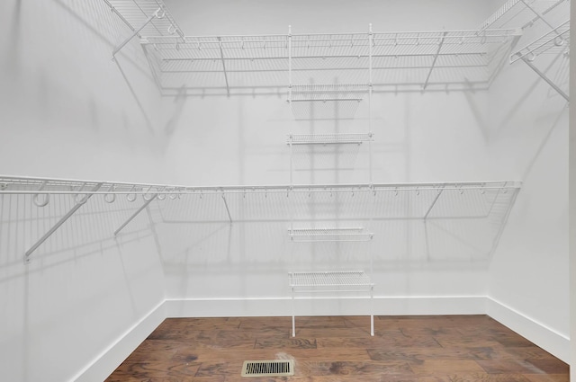 walk in closet featuring visible vents and wood finished floors