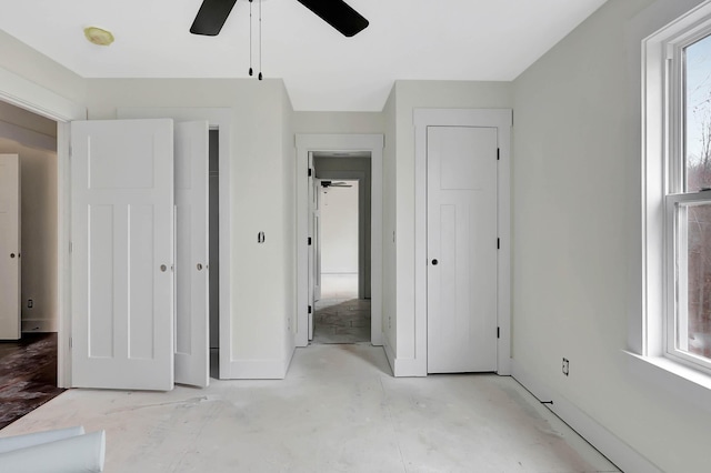 unfurnished bedroom with a ceiling fan and baseboards