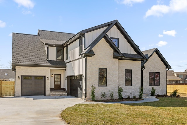 modern farmhouse style home featuring a shingled roof, concrete driveway, board and batten siding, a front yard, and fence