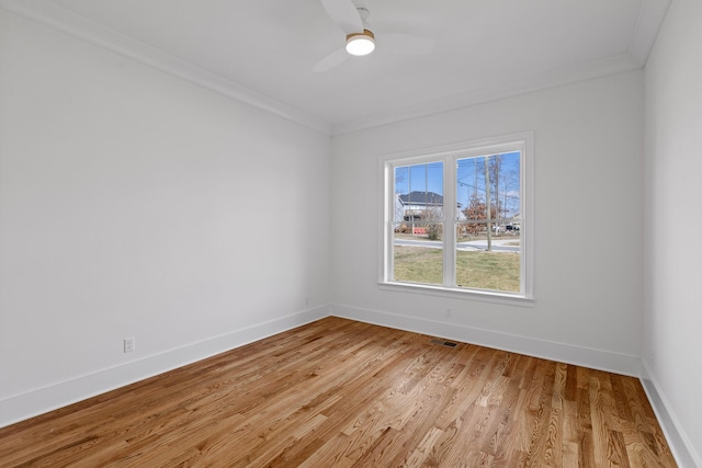 unfurnished room with a ceiling fan, crown molding, light wood-style flooring, and baseboards