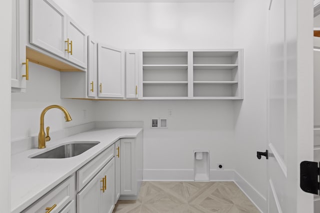 laundry area with hookup for a washing machine, a sink, baseboards, cabinet space, and electric dryer hookup