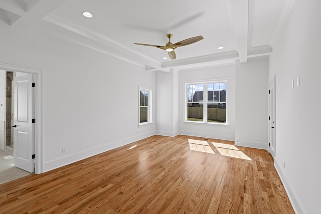 interior space featuring ceiling fan, light wood-style flooring, recessed lighting, baseboards, and a tray ceiling