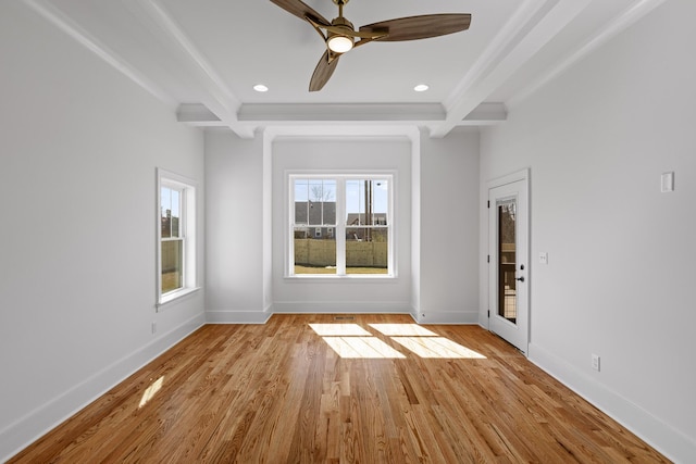 empty room with light wood finished floors, beamed ceiling, recessed lighting, and baseboards