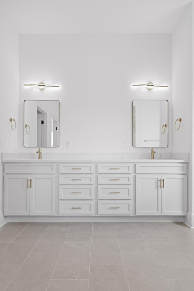 full bathroom with double vanity and a sink