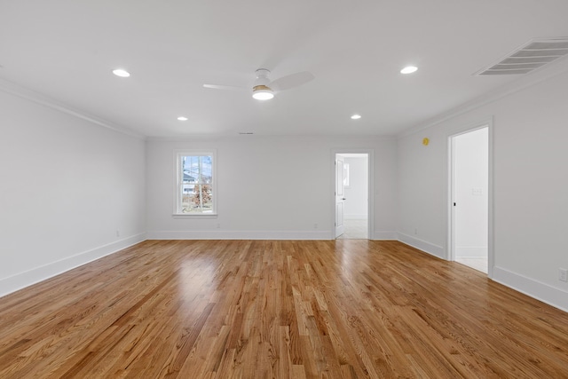 unfurnished living room with ornamental molding, visible vents, light wood-style flooring, and baseboards