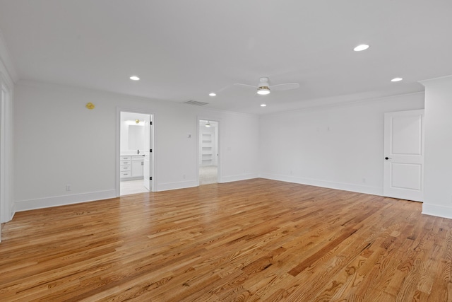 empty room featuring crown molding, recessed lighting, visible vents, and light wood-style floors