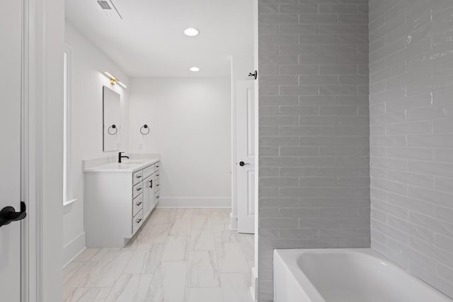 full bathroom featuring a tub to relax in, visible vents, vanity, baseboards, and marble finish floor