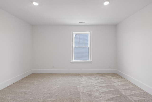 empty room with light carpet, baseboards, visible vents, and recessed lighting