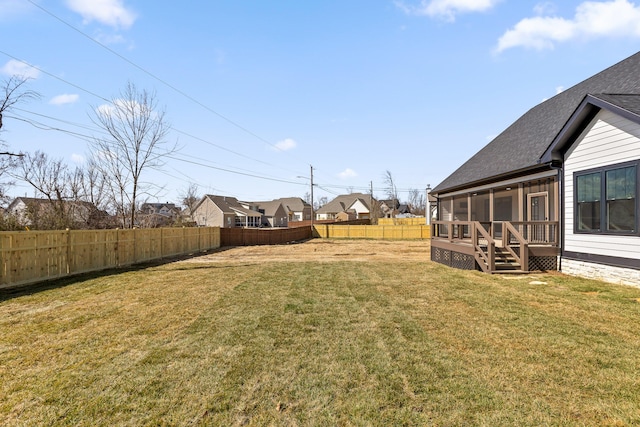 view of yard with a sunroom, a fenced backyard, and a deck