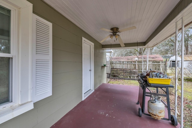 view of patio with ceiling fan and fence