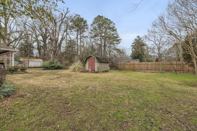 view of yard with a storage unit, an outdoor structure, and fence