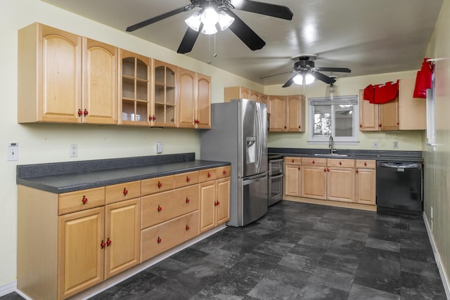 kitchen with a sink, dark countertops, glass insert cabinets, and stainless steel appliances