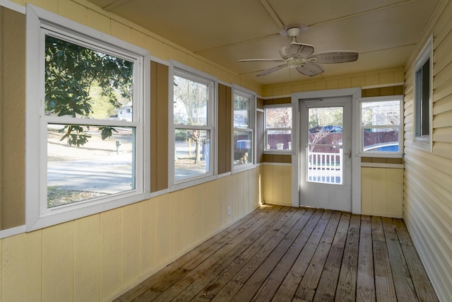 unfurnished sunroom featuring a ceiling fan