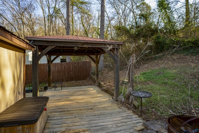 wooden deck featuring a gazebo and fence