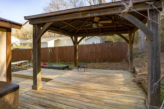 wooden deck featuring a gazebo and fence