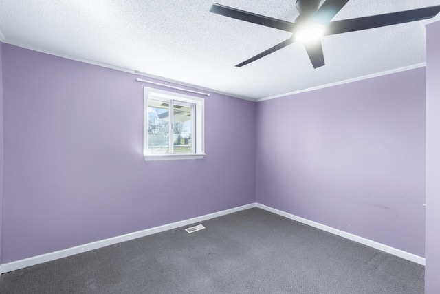 carpeted empty room featuring visible vents, a textured ceiling, crown molding, and baseboards