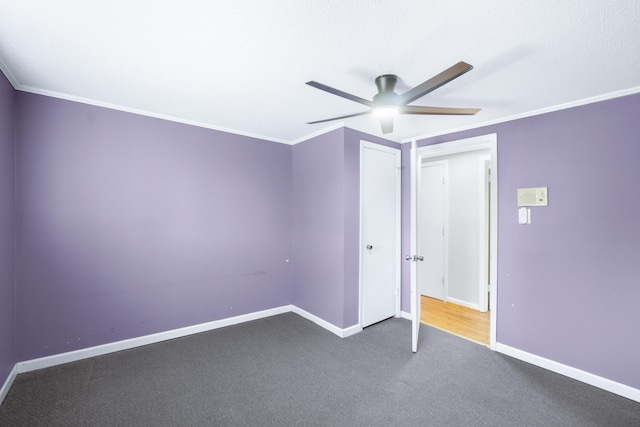 unfurnished bedroom with a ceiling fan, baseboards, carpet floors, and ornamental molding