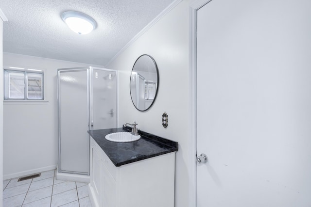 full bathroom featuring visible vents, a textured ceiling, a shower stall, and tile patterned flooring