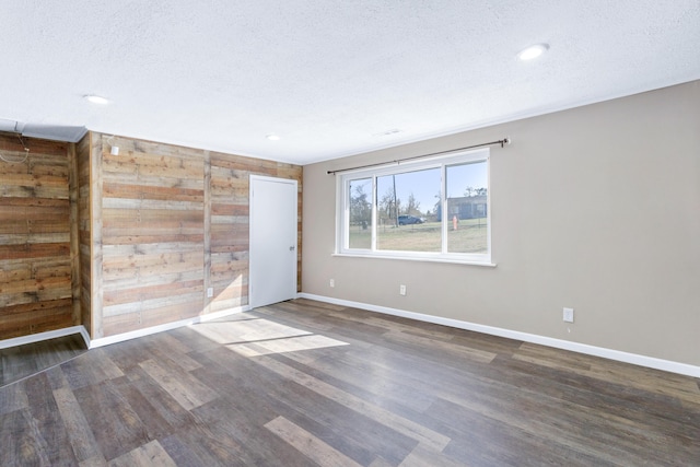 unfurnished room featuring recessed lighting, a textured ceiling, baseboards, and wood finished floors