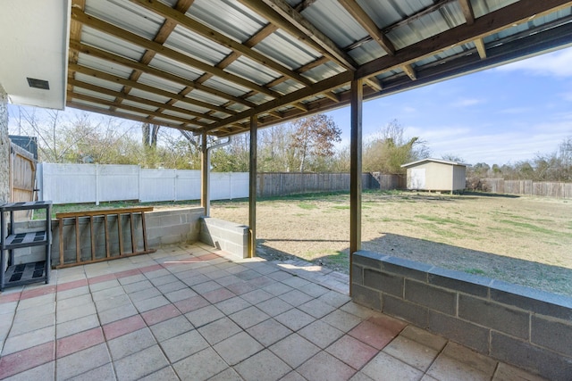 view of patio / terrace featuring a fenced backyard, a storage unit, and an outdoor structure