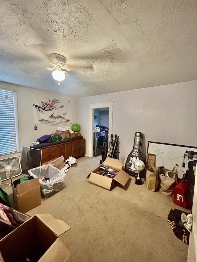 miscellaneous room with a textured ceiling, ceiling fan, and carpet flooring