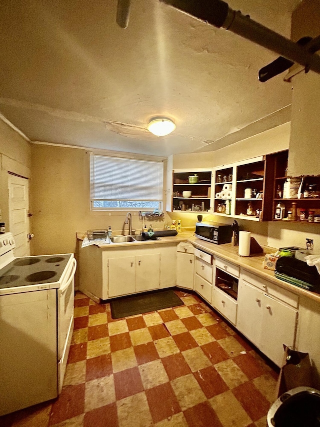 kitchen with white electric stove, white cabinets, stainless steel microwave, tile patterned floors, and a sink