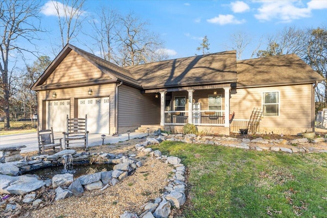 view of front of property with driveway, a porch, and an attached garage