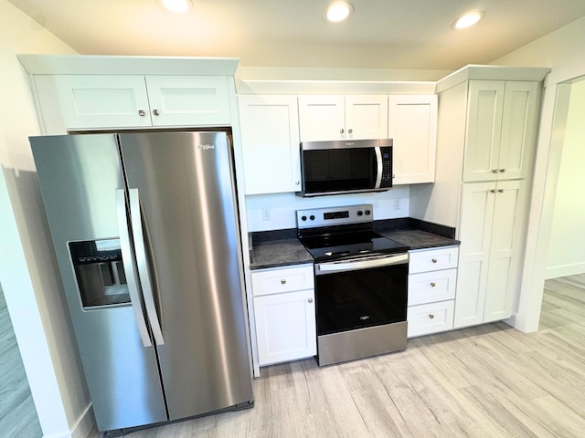 kitchen featuring light wood finished floors, appliances with stainless steel finishes, white cabinets, and recessed lighting