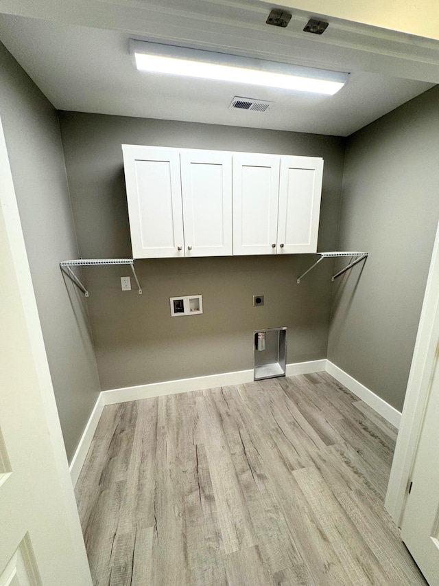 clothes washing area featuring hookup for a washing machine, visible vents, cabinet space, light wood finished floors, and electric dryer hookup