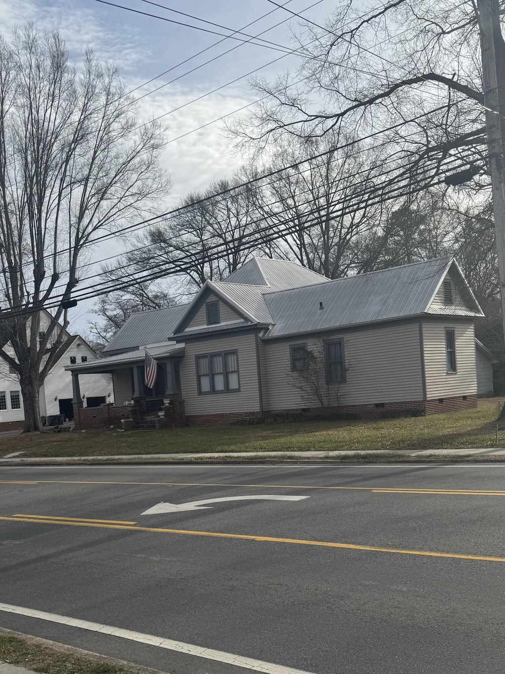 view of front of property with crawl space and metal roof