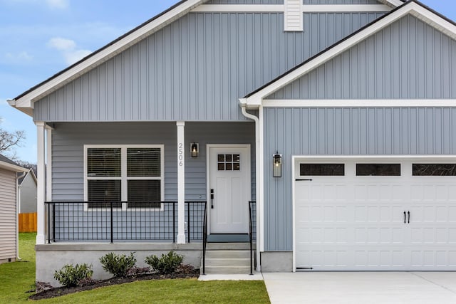 modern farmhouse featuring an attached garage, board and batten siding, a porch, and concrete driveway