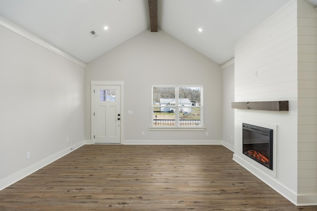 unfurnished living room featuring beam ceiling, a large fireplace, wood finished floors, high vaulted ceiling, and baseboards