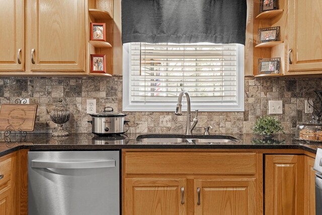 kitchen featuring open shelves, tasteful backsplash, dark countertops, stainless steel dishwasher, and a sink