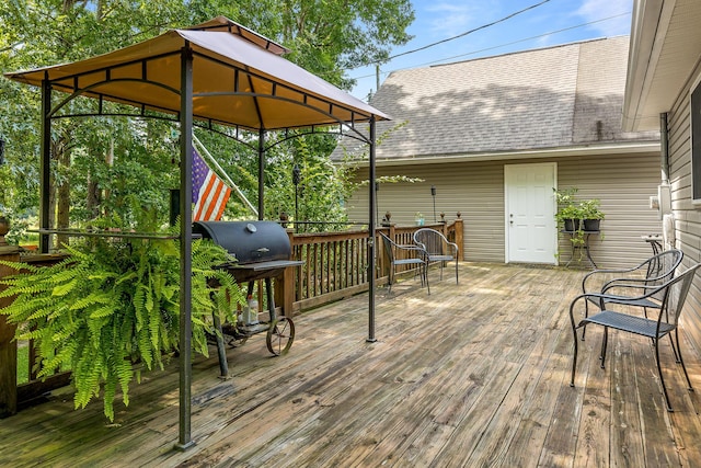 wooden terrace with area for grilling and a gazebo