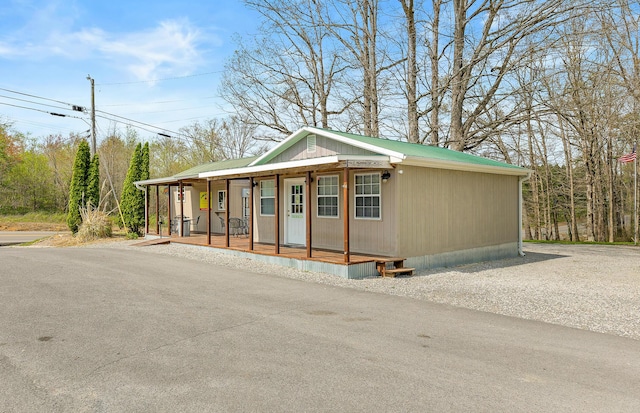 view of front of property featuring covered porch and metal roof