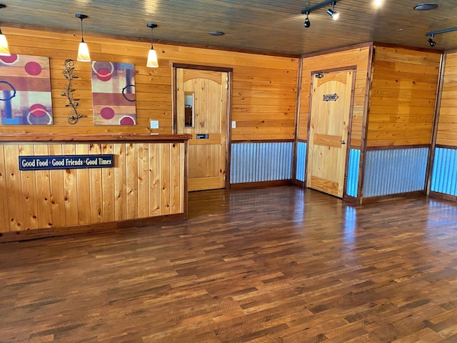 interior space featuring wooden ceiling, wooden walls, track lighting, and wood finished floors