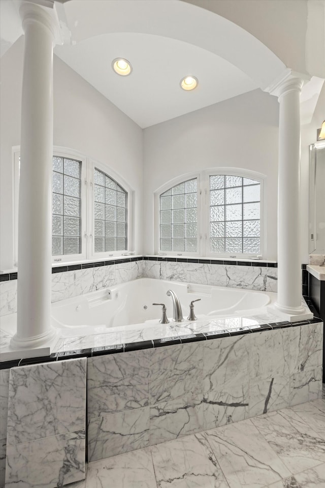 bathroom with ornate columns, marble finish floor, a bath, and recessed lighting