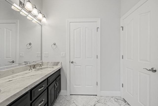 bathroom featuring marble finish floor, vanity, and baseboards