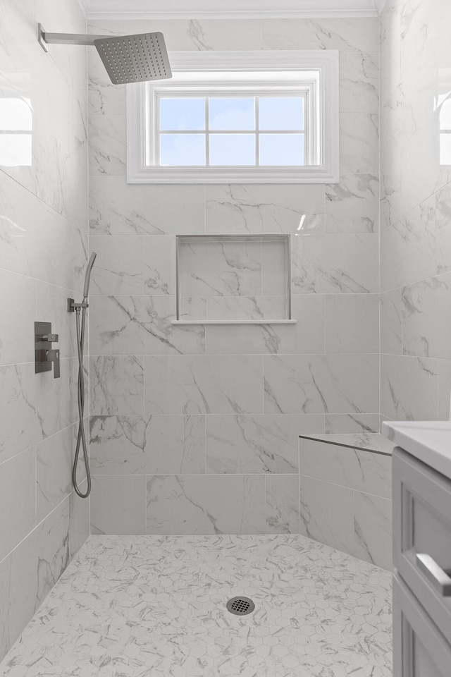 full bathroom featuring vanity and tiled shower