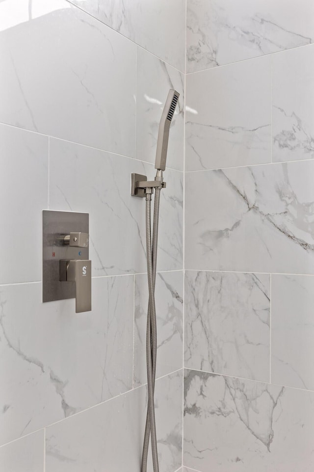 room details featuring a marble finish shower