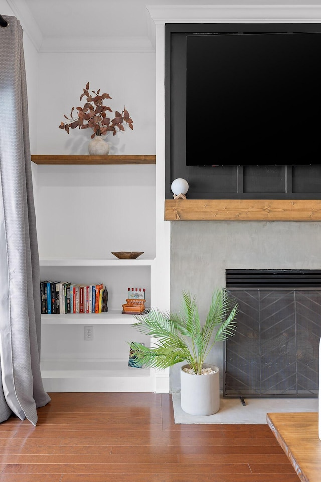 room details featuring ornamental molding and wood finished floors