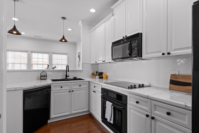 kitchen with black appliances, white cabinets, tasteful backsplash, and a sink