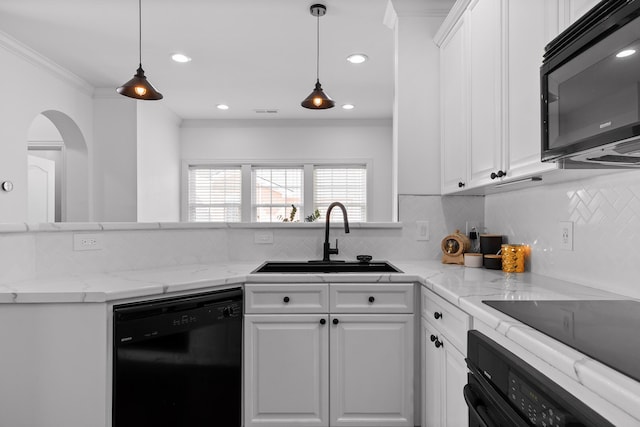 kitchen with backsplash, ornamental molding, white cabinets, black appliances, and a sink