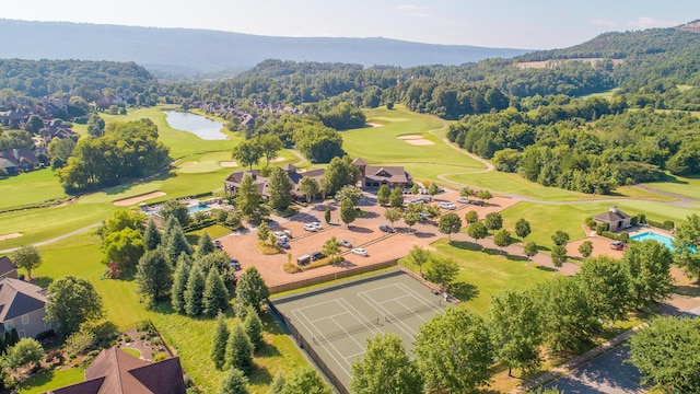 drone / aerial view with golf course view and a view of trees