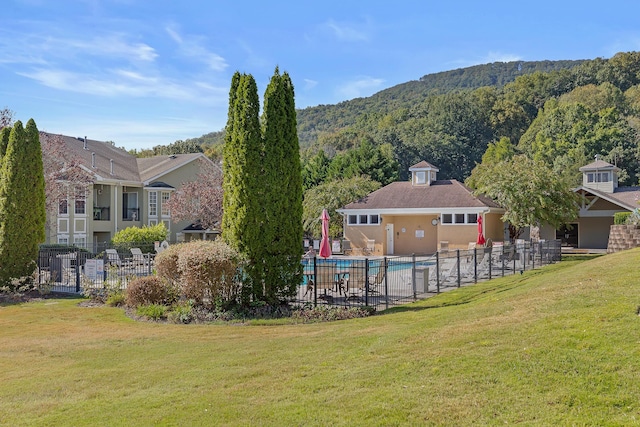 exterior space with a yard, fence, and a mountain view