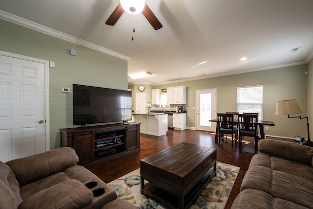 living room with a ceiling fan, visible vents, baseboards, dark wood finished floors, and ornamental molding