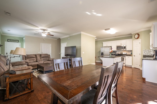 dining space featuring visible vents, dark wood-type flooring, ceiling fan, and crown molding