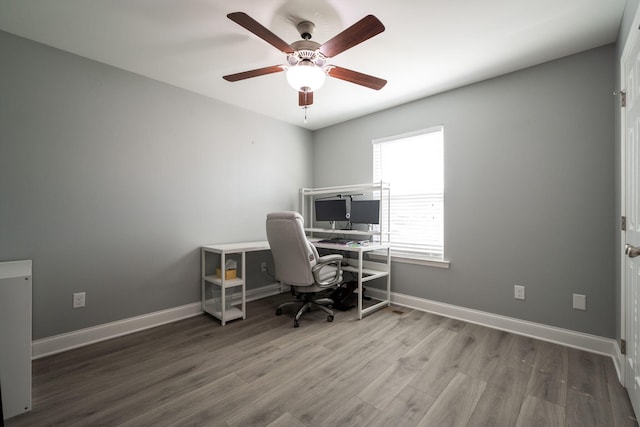 office featuring baseboards, wood finished floors, and a ceiling fan