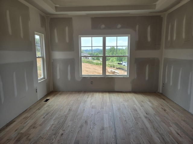 empty room with wood finished floors and visible vents